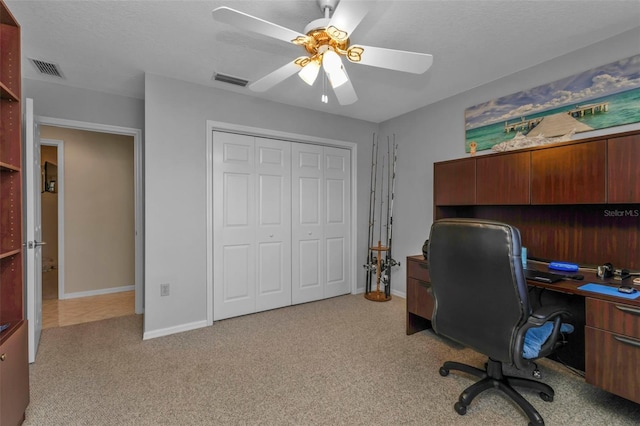 office with light carpet and ceiling fan