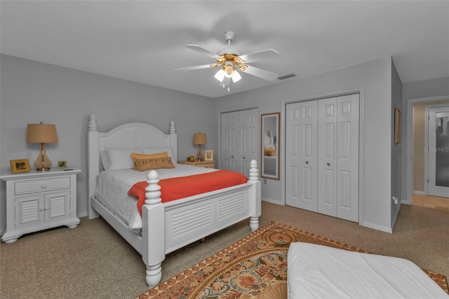 bedroom featuring ceiling fan, carpet, and two closets