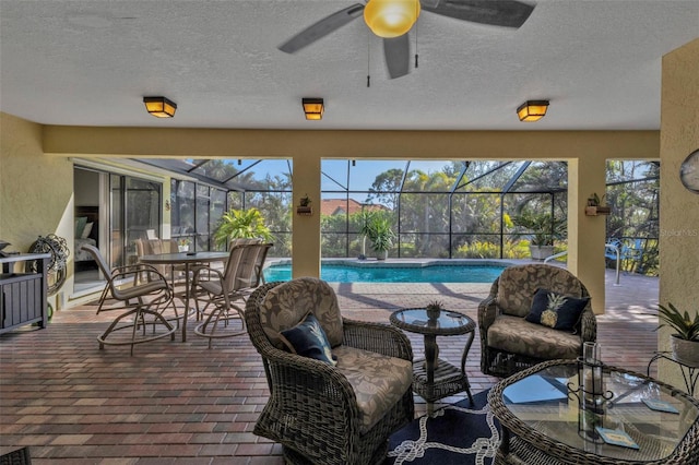 exterior space with plenty of natural light, ceiling fan, and a swimming pool