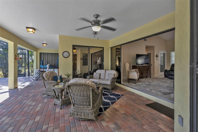 view of patio featuring an outdoor living space, an outdoor kitchen, and ceiling fan