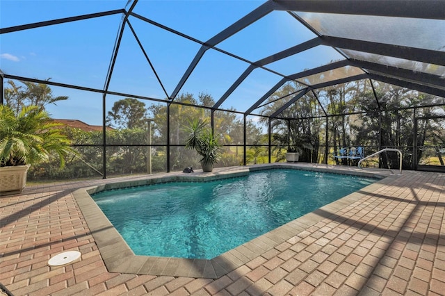 view of pool featuring glass enclosure and a patio