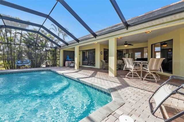 view of swimming pool featuring a patio, ceiling fan, and a lanai