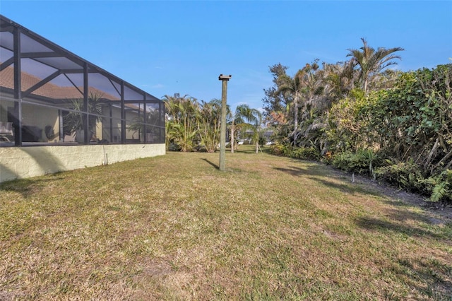 view of yard featuring glass enclosure