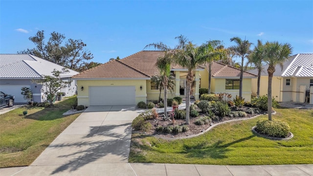 mediterranean / spanish home featuring a front lawn and a garage