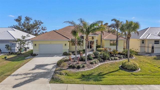 mediterranean / spanish house featuring a garage and a front lawn