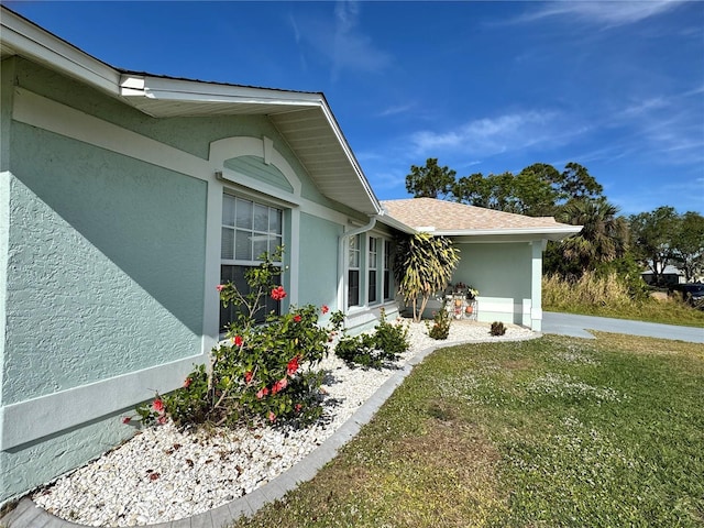 view of side of property with a lawn