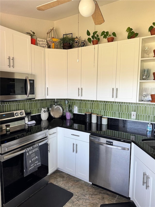 kitchen with appliances with stainless steel finishes, white cabinetry, and ceiling fan