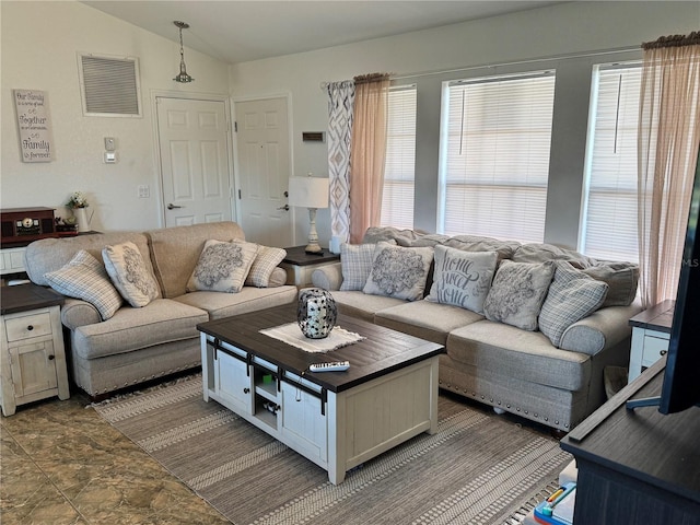 living room with a healthy amount of sunlight and lofted ceiling