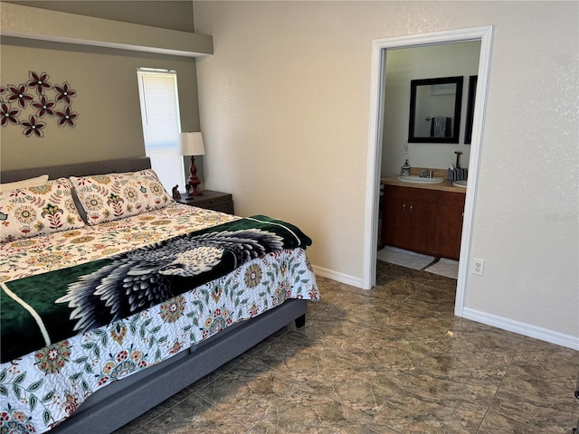 bedroom with ensuite bath and sink