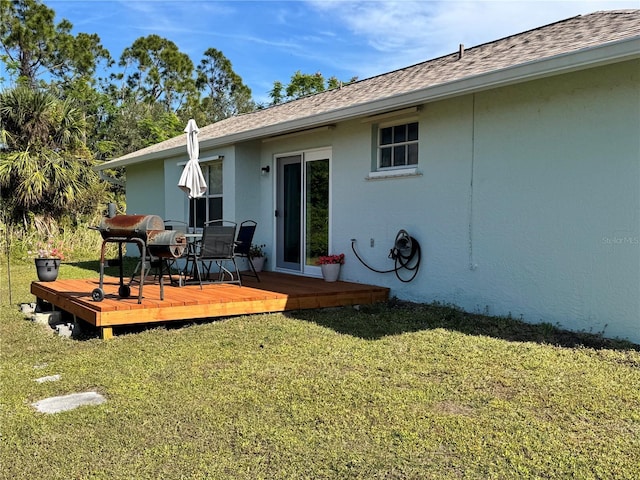 back of property featuring a yard and a deck