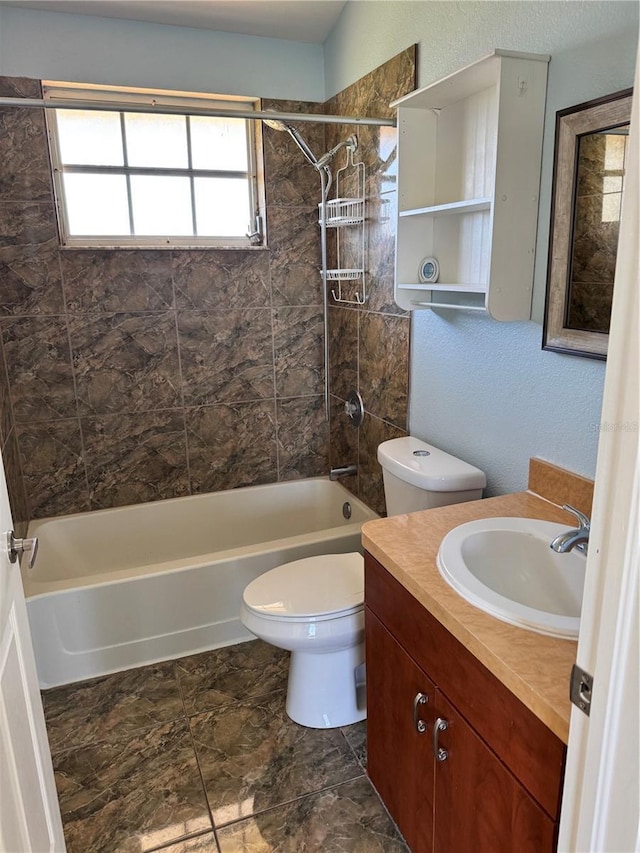 full bathroom with vanity, toilet, and tiled shower / bath combo