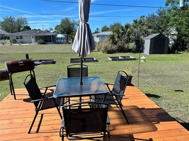 wooden deck featuring a storage unit, area for grilling, and a yard