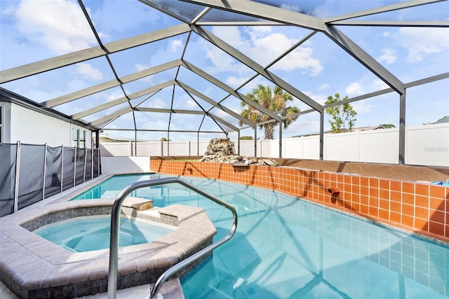 view of swimming pool with glass enclosure and an in ground hot tub