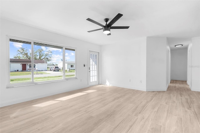 unfurnished living room featuring ceiling fan and light wood-type flooring