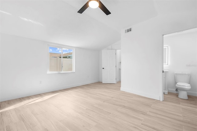 unfurnished bedroom with connected bathroom, ceiling fan, light hardwood / wood-style floors, and lofted ceiling