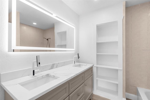 bathroom with vanity and tiled shower / bath combo