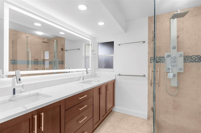 bathroom featuring tile patterned floors, vanity, and a shower with door