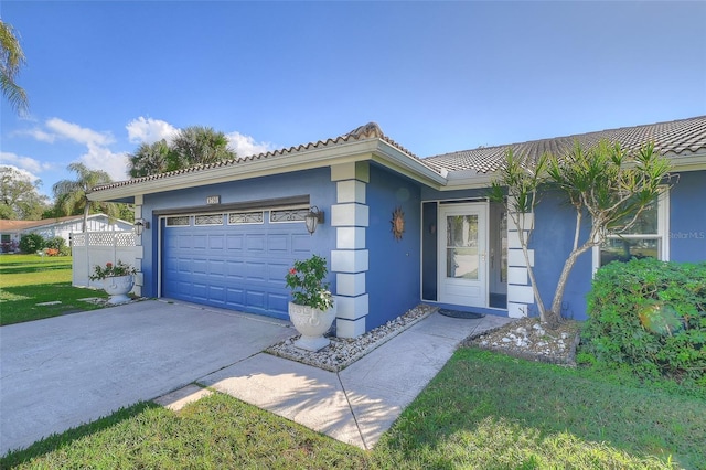 ranch-style house featuring a garage and a front lawn