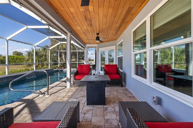 view of swimming pool featuring french doors, an outdoor hangout area, ceiling fan, a lanai, and a patio area