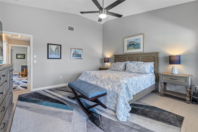 bedroom featuring ceiling fan, lofted ceiling, and light hardwood / wood-style flooring