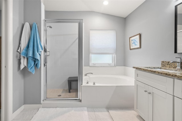 bathroom with tile patterned flooring, vanity, vaulted ceiling, and plus walk in shower