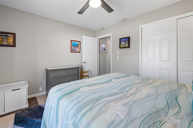 bedroom with ceiling fan, dark hardwood / wood-style floors, and a closet