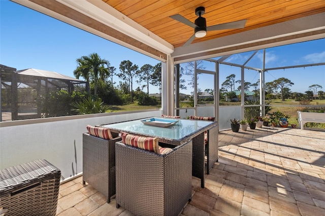 wooden deck featuring a lanai, ceiling fan, and a patio