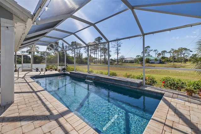 pool with glass enclosure and a patio area