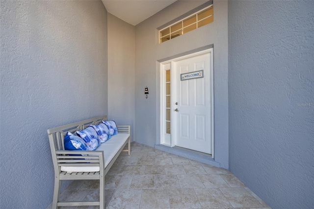 doorway to property featuring stucco siding