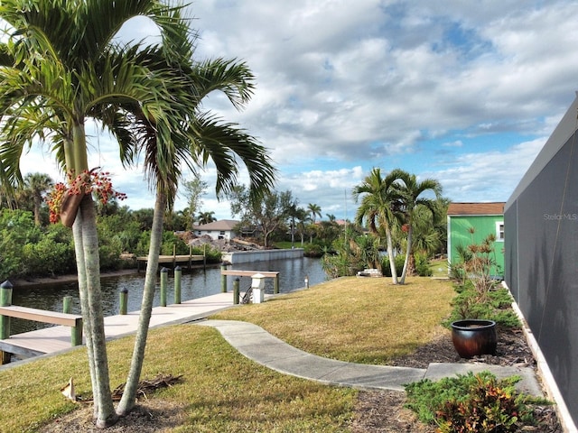 view of yard featuring a dock and a water view