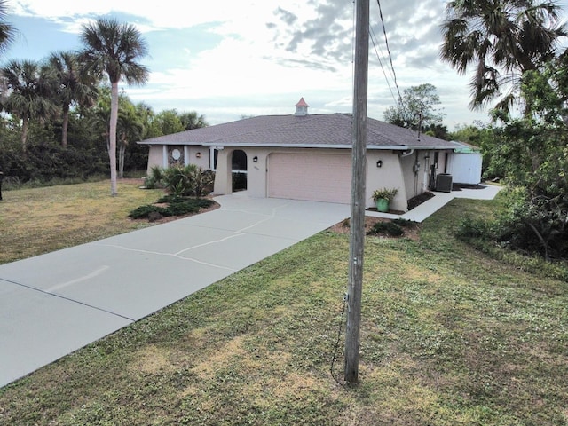 ranch-style house with central AC unit, a garage, and a front lawn