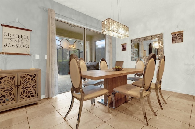 tiled dining room featuring an inviting chandelier