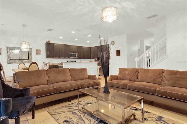 5240 Oakbourne Ave, Davenport, FL 33837 - living area with light tile patterned flooring, stairway, and recessed lighting