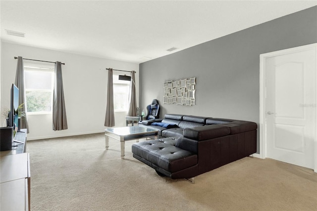 carpeted living room with a healthy amount of sunlight