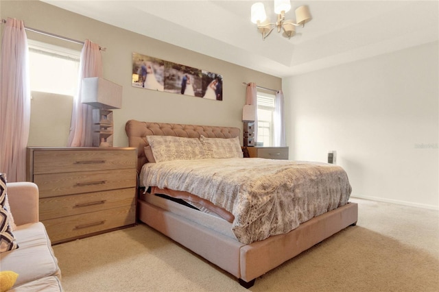 bedroom featuring light carpet and a chandelier