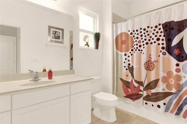 bathroom featuring tile patterned flooring, vanity, and toilet