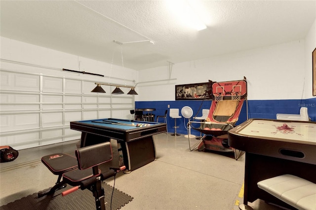 recreation room with a textured ceiling and pool table