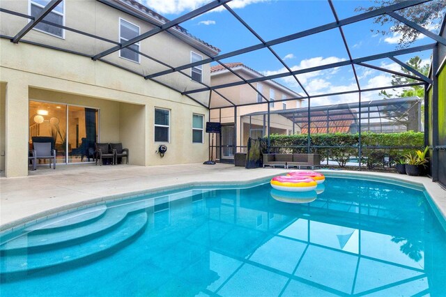 view of pool with a lanai and a patio