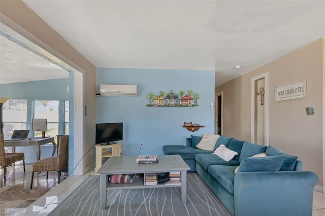 living room featuring light tile patterned floors and an AC wall unit