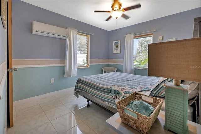 bedroom featuring ceiling fan, light tile patterned floors, and a wall unit AC