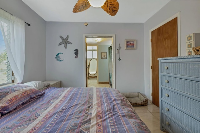 tiled bedroom with ceiling fan and ensuite bathroom