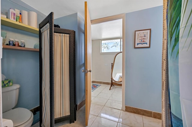 bathroom with tile patterned floors and toilet