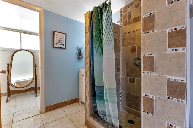 bathroom with curtained shower and tile patterned floors