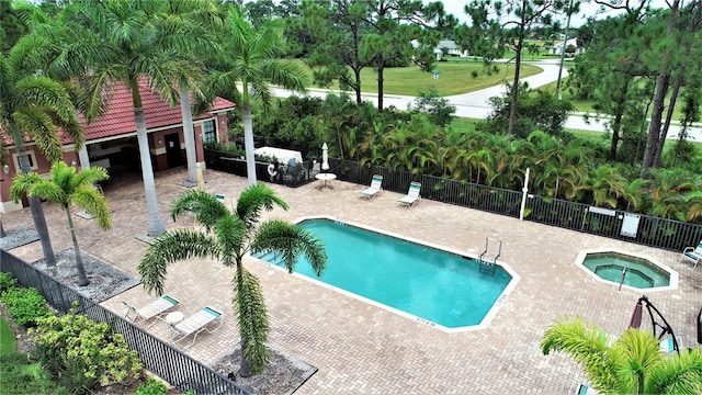 view of pool featuring a patio and a hot tub