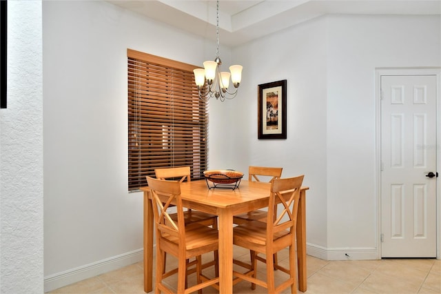 tiled dining area featuring a chandelier