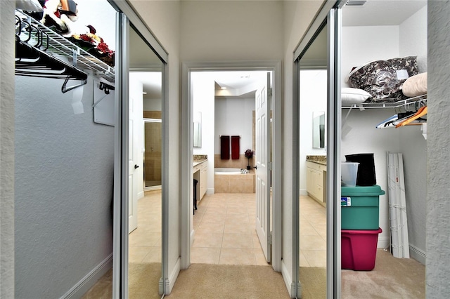 corridor featuring light tile patterned flooring