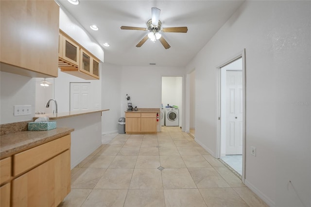 kitchen featuring light brown cabinetry, washer / dryer, sink, light tile patterned floors, and ceiling fan