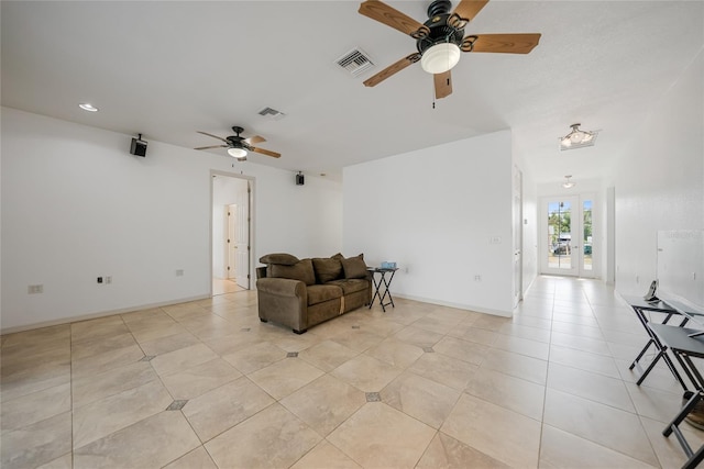 tiled living room featuring french doors and ceiling fan