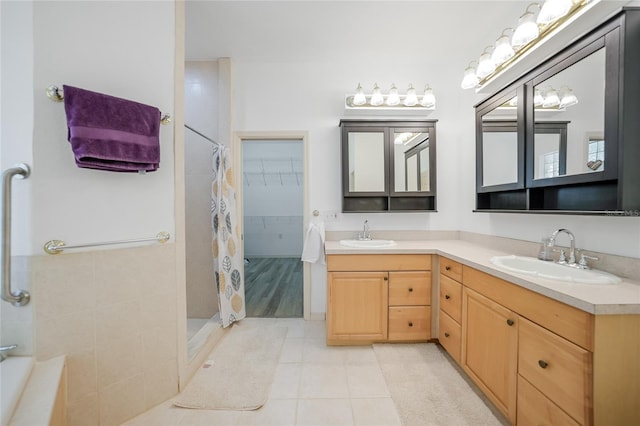 bathroom with tile patterned flooring, vanity, and curtained shower