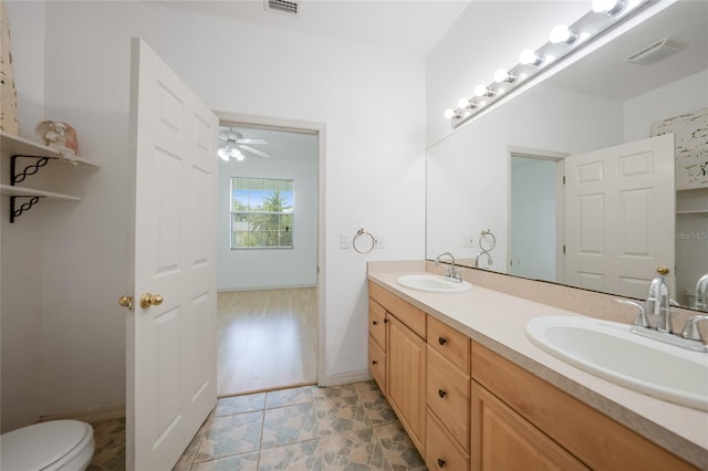 bathroom with vanity, ceiling fan, and toilet